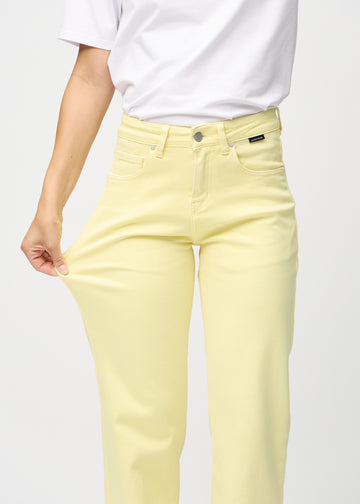 Model strækker jeansene ved låret for at vise stretch.