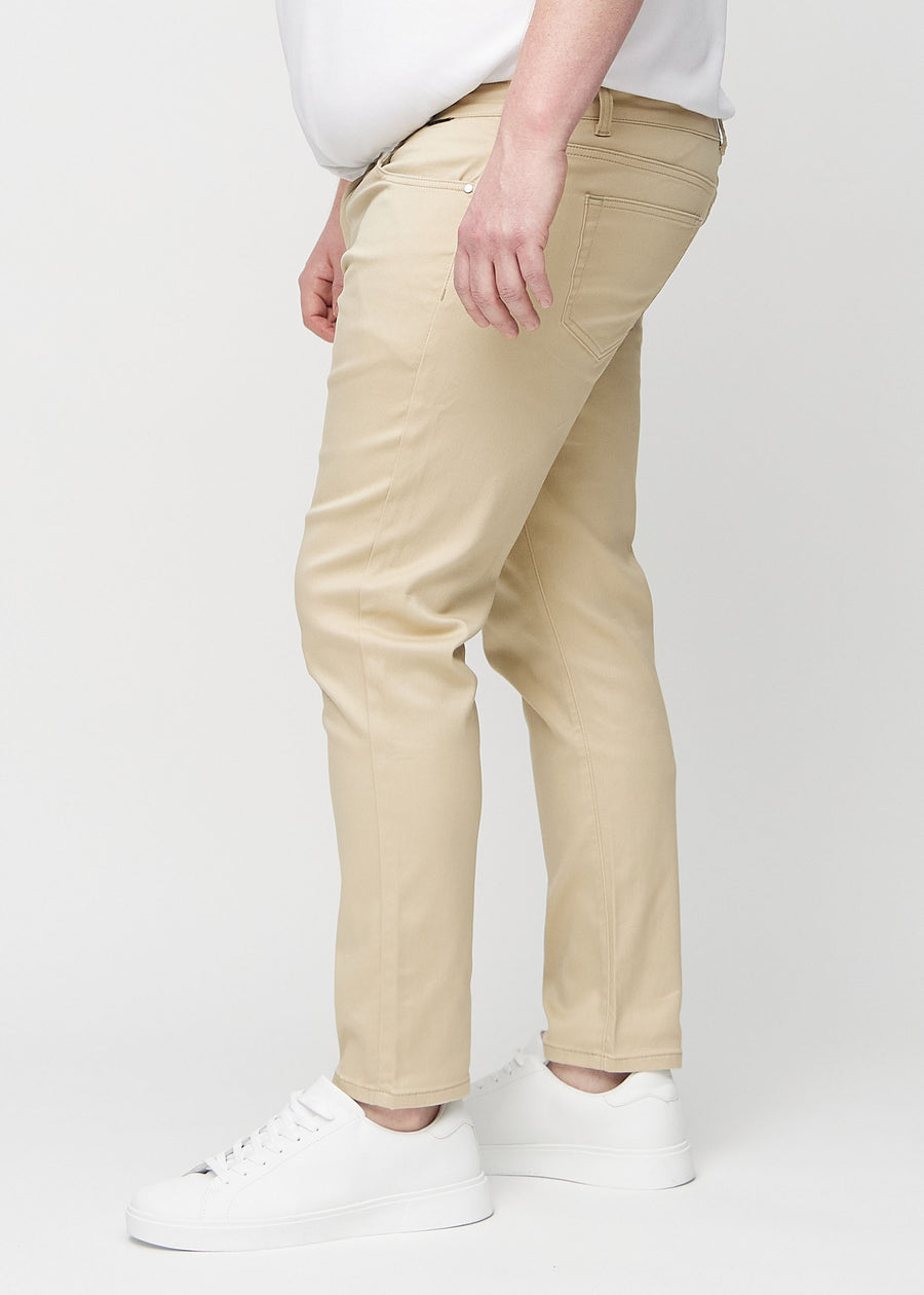 Beige slim jeans set fra siden på en plus-size model.