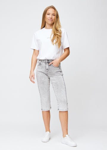 Full image of model in light grey denim regular capris.