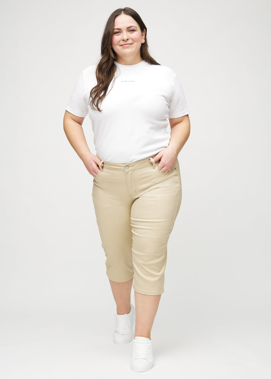 Full image of a plus-size model in beige regular capris.