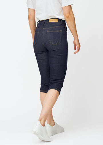 Deep dark blue denim capris for women in the colour Midnights seen from the back.