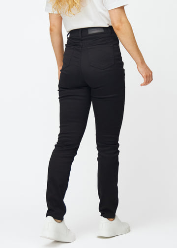 Black high-waisted slim jeans seen from the back, so the entire product can be seen.
