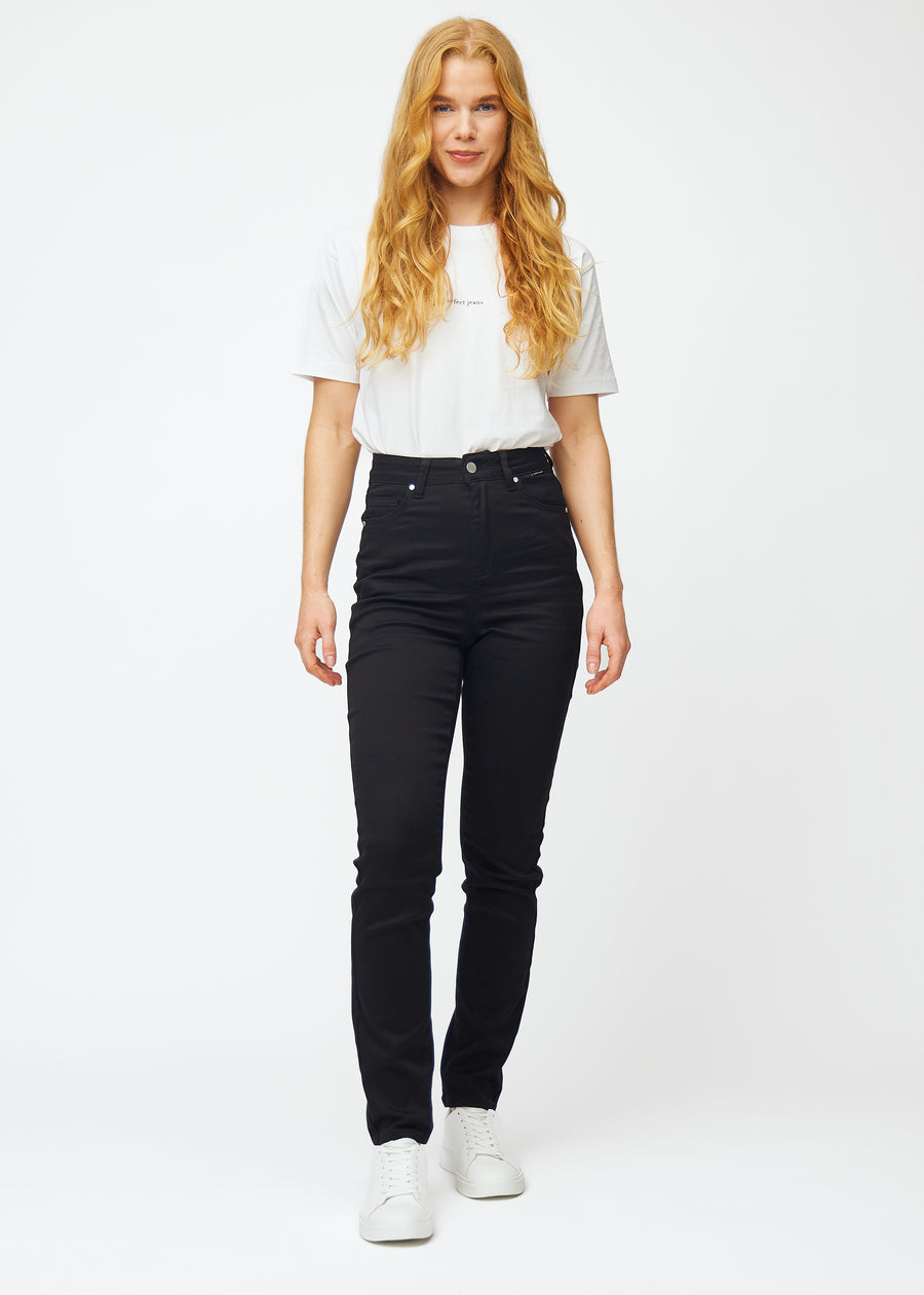 Full image of a model in black high-waisted slim jeans.
