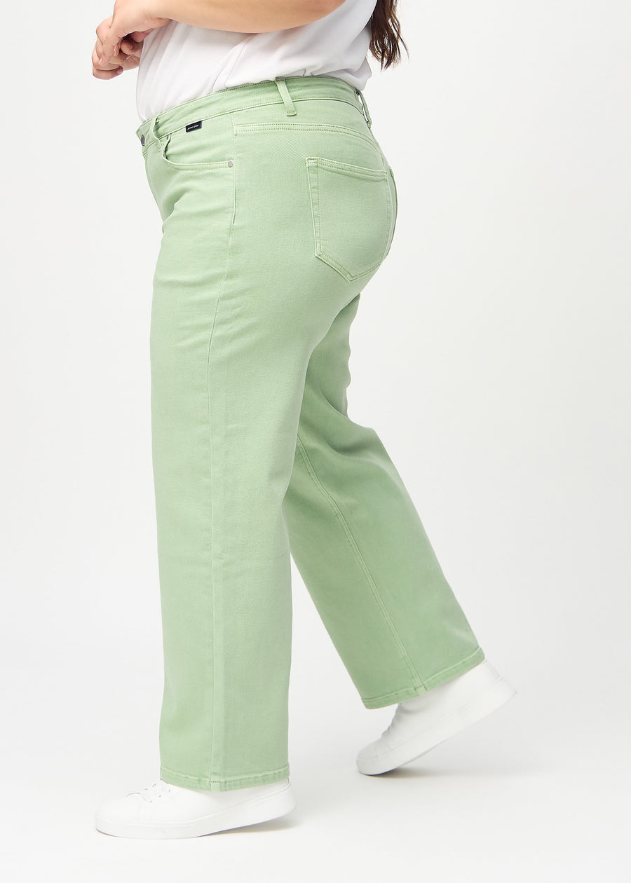 Loose jeans for women in light green, color Mints. Side view on a plus-size model, showing the loose fit.