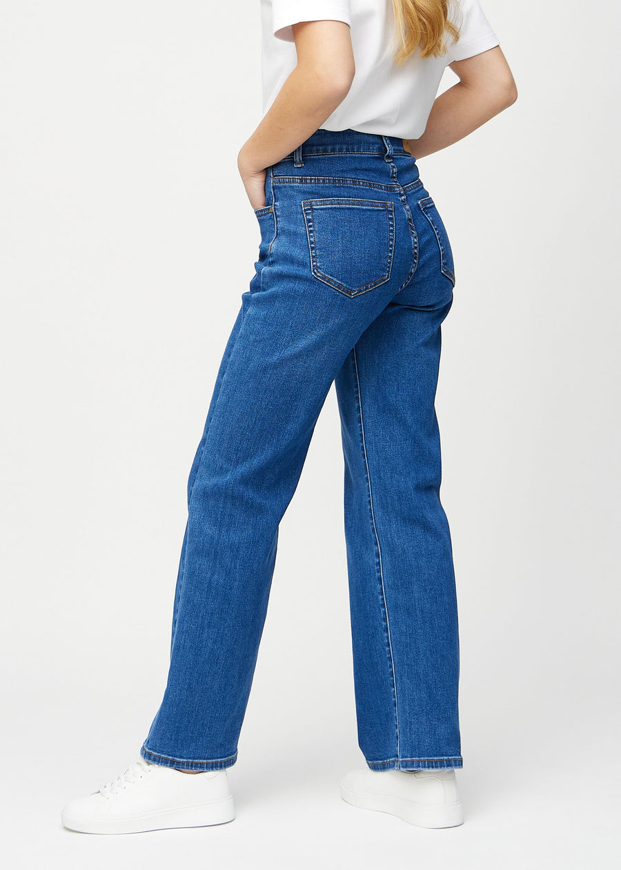 Dark denim loose jeans seen from the side on a model.