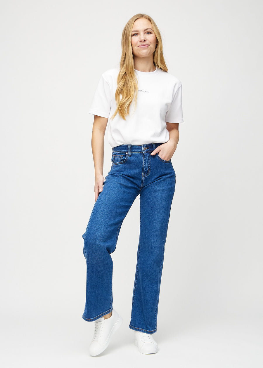 Full image of model in dark denim loose jeans.