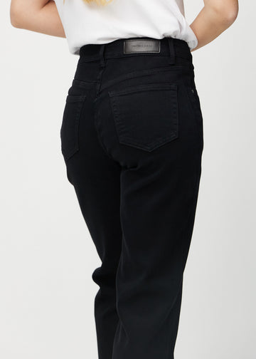 Black loose jeans seen from the back close up to show details.