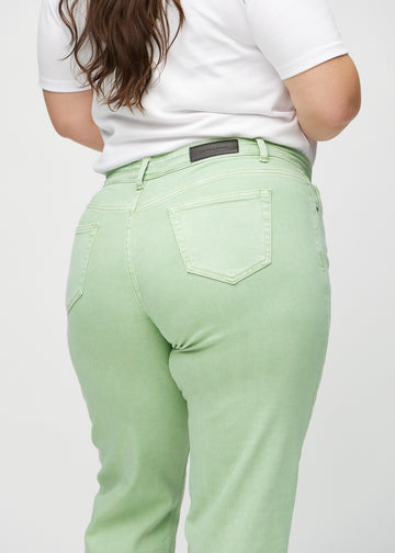 Regular jeans for women in light green, color Mints. Close-up from behind on a plus-size model, showing fit and details.