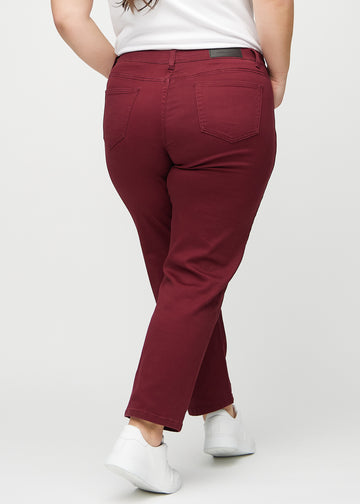 Regular jeans for women in dark red, color Santas. Back view on a plus-size model, showing the full fit.