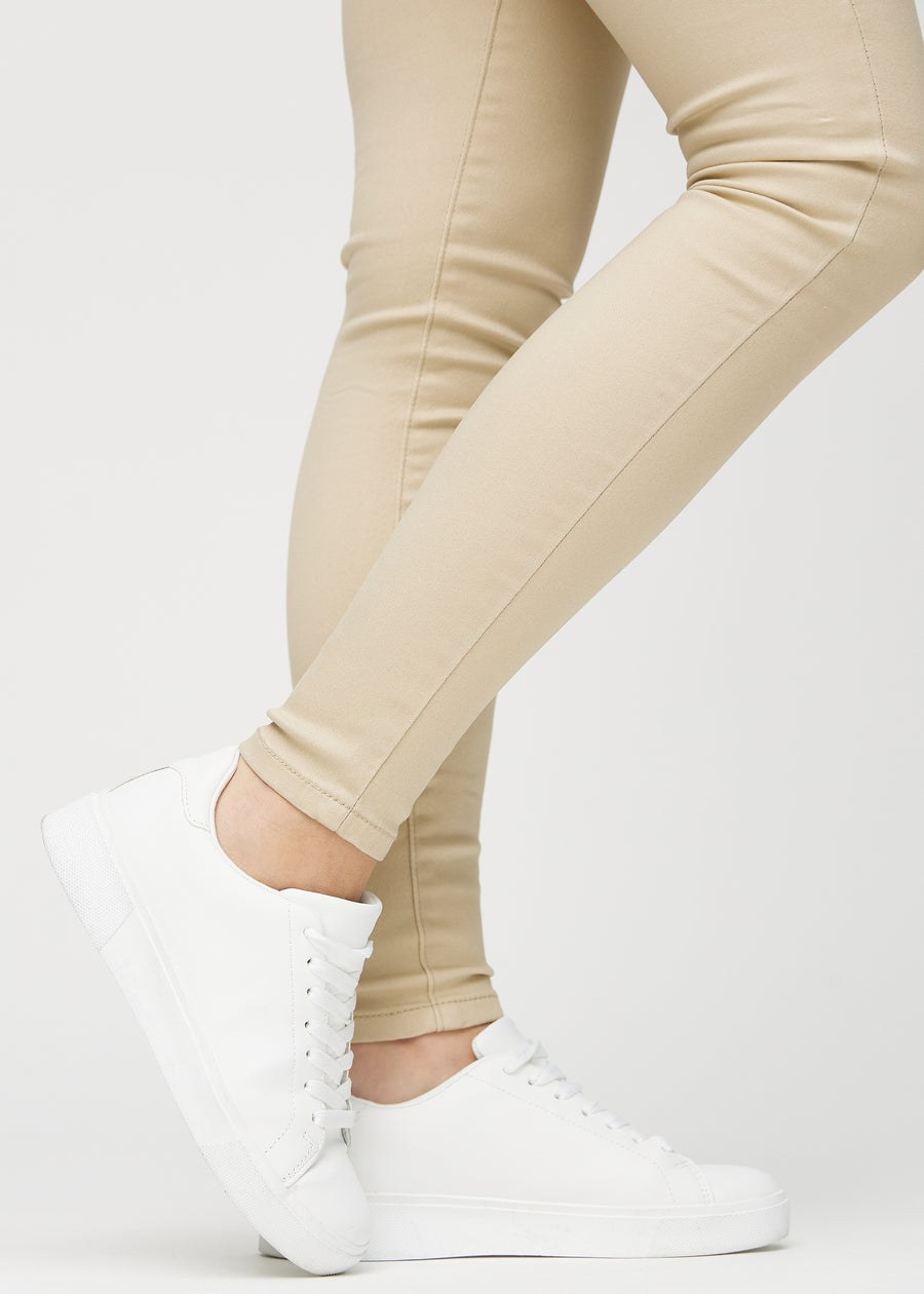 The ankles of a model, so you can see how tightly the jeans fit.