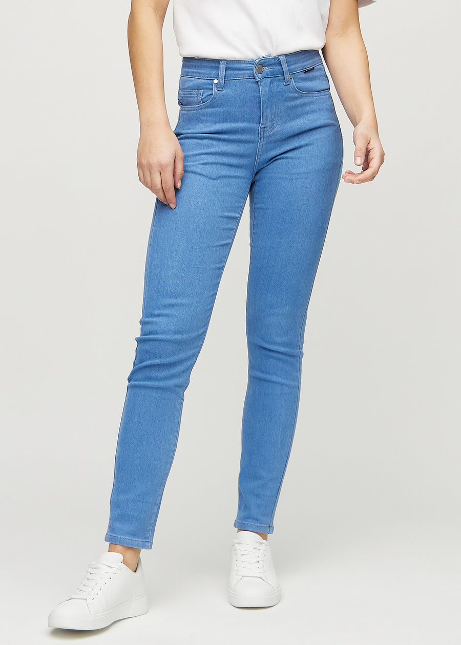 Slim jeans for women in blue, color Geraniums. Front view on a model, showing a close fit through the leg with a little more room at the ankle.