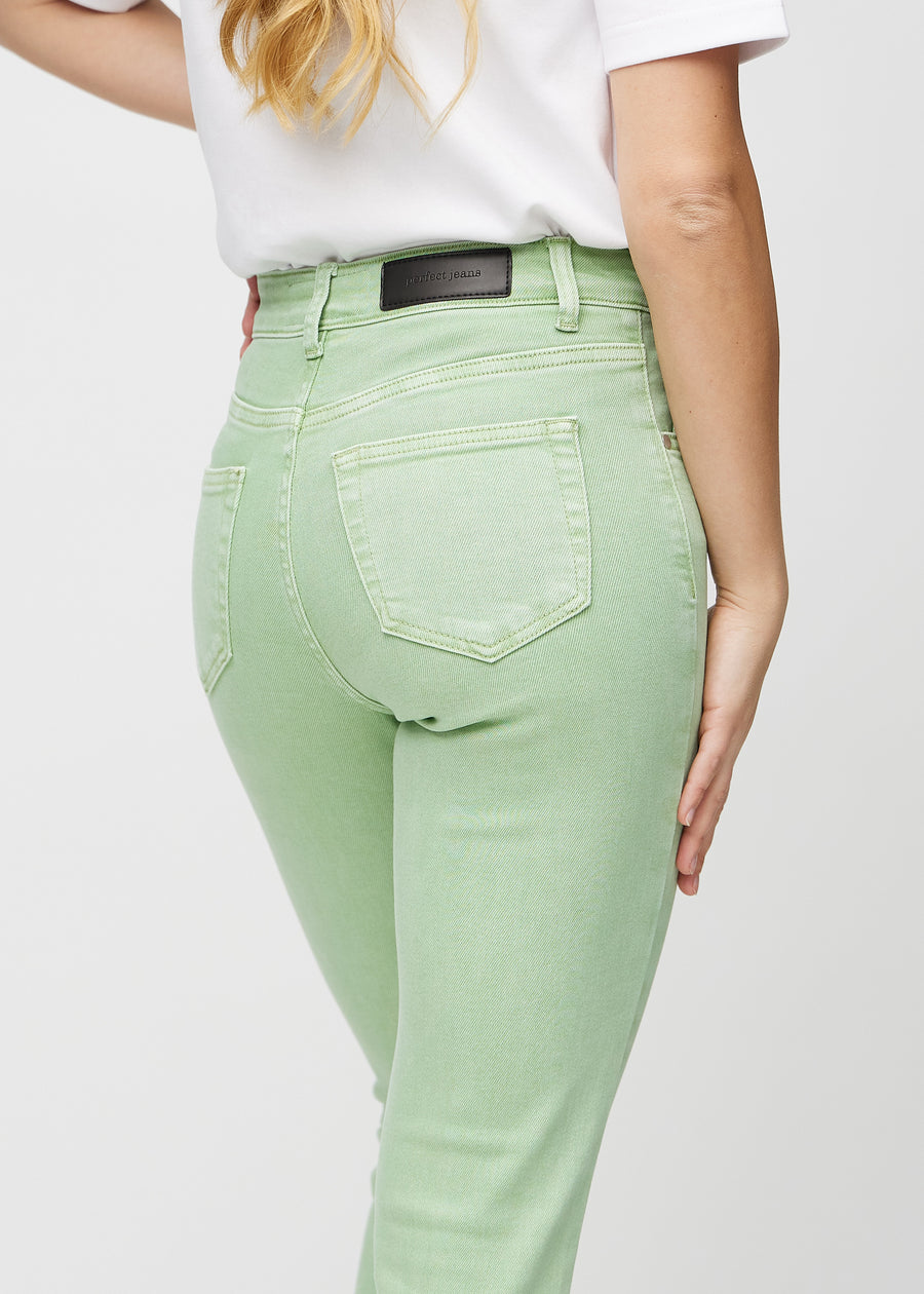 Slim jeans for women in light green, color Mints. Close-up back view on a model, showing the details.