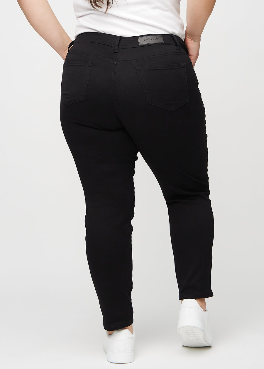 Black slim jeans seen from the back on a plus-size model, so the entire product can be seen.