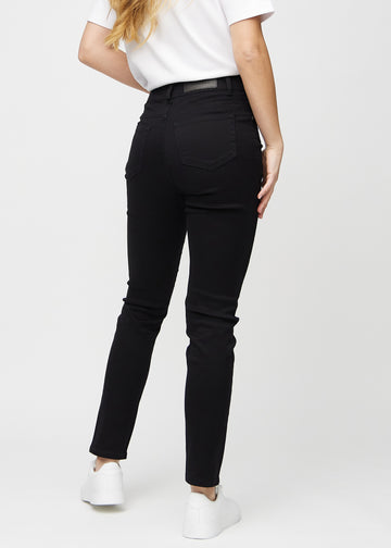 Black slim jeans seen from the back, so the entire product can be seen.