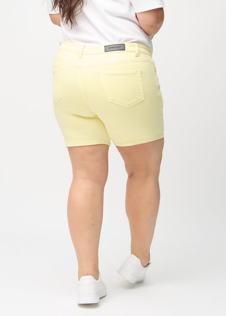 Light yellow skinny short shorts seen from the back on a plus-size model, so the entire product can be seen.