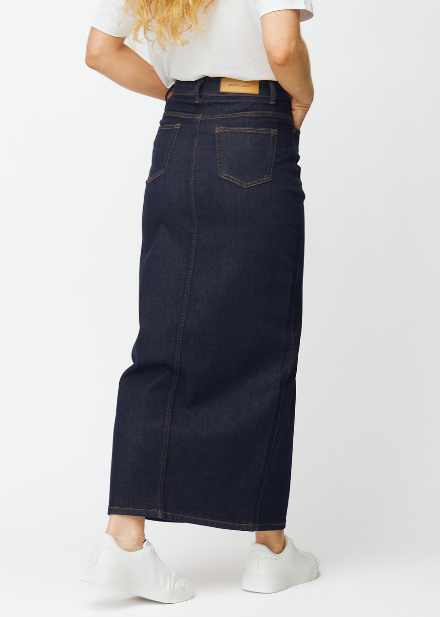 Long deep dark blue denim skirt for women in the colour Midnights seen from the back, showing the full length.
