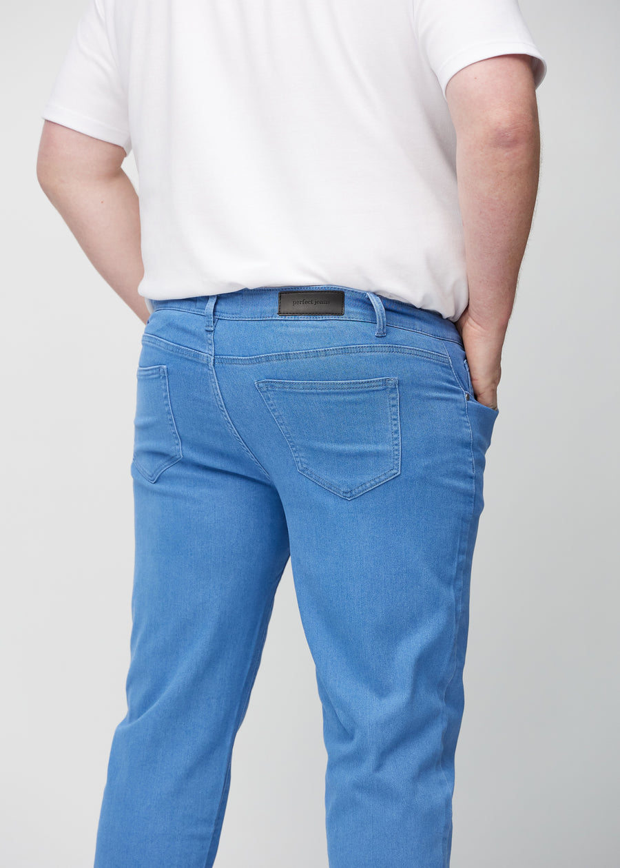 Blue regular jeans seen from the back close up on a plus-size model to show details.