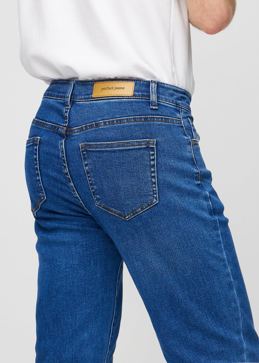 Dark blue denim regular jeans seen from the back close up to show details.