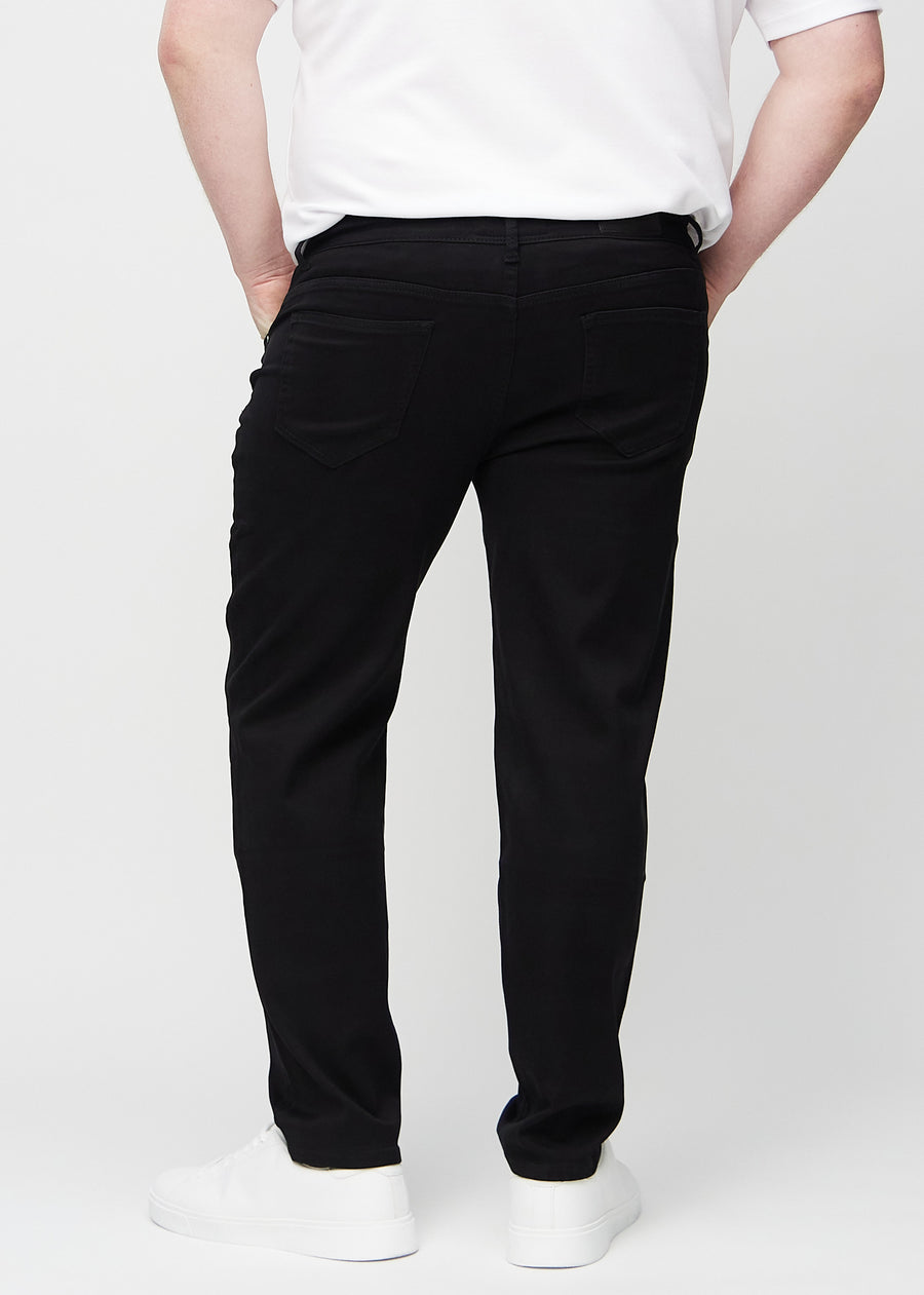 Black regular jeans seen from the back on a plus-size model, so you can see the entire product.