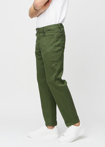 Dark green regular jeans seen from the side on a model.