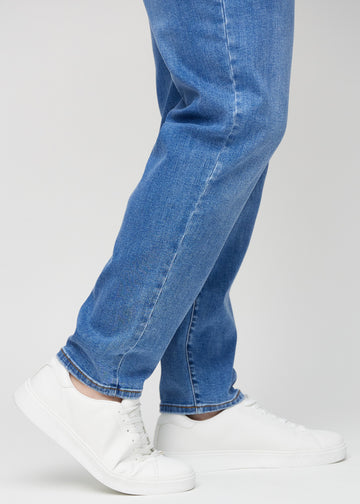 The ankles on a plus-size model, so you can see how loose the jeans fit.