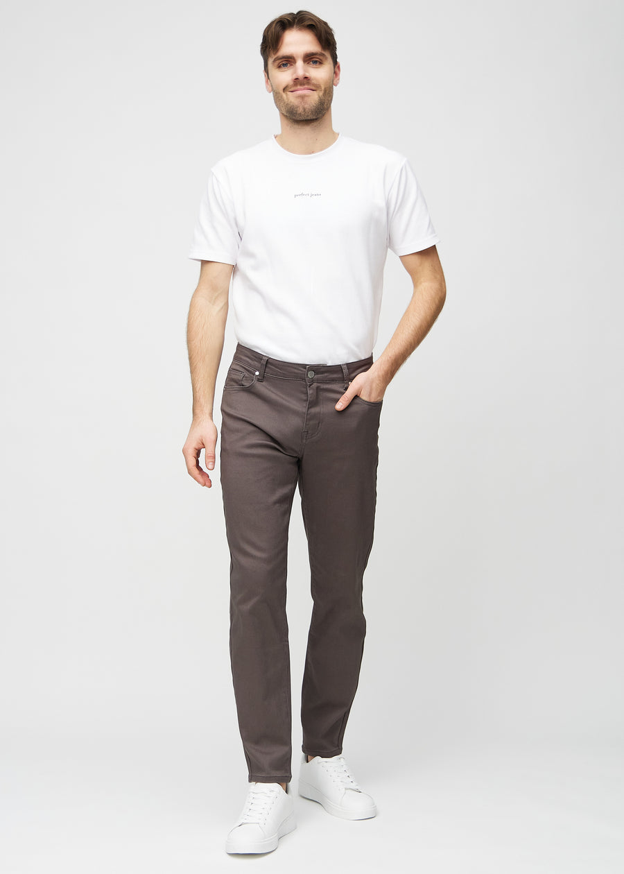 Full image of model in grey-brown regular jeans.