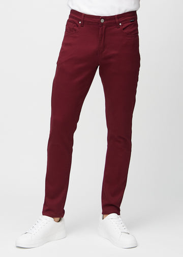 Dark red slim jeans, model name Santas, fitted closely along the legs, front view.