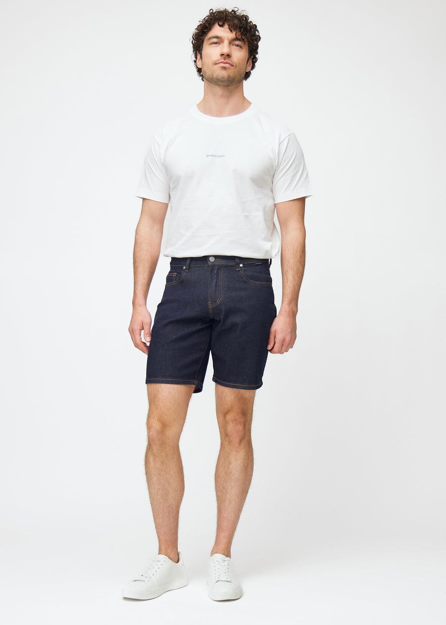 full image of a model wearing deep dark blue denim shorts for men in the colour midnights with a regular fit.