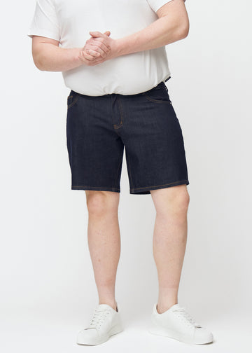 deep dark blue denim shorts for men in the colour midnights with a regular fit seen from the front on a plus-size model.