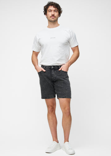 Full image of a model wearing dark grey denim shorts for men in the colour Shadows with a regular fit.