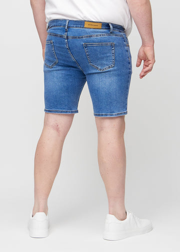 Denim middle-slim shorts seen from the back on a plus-size model, so the entire product can be seen.